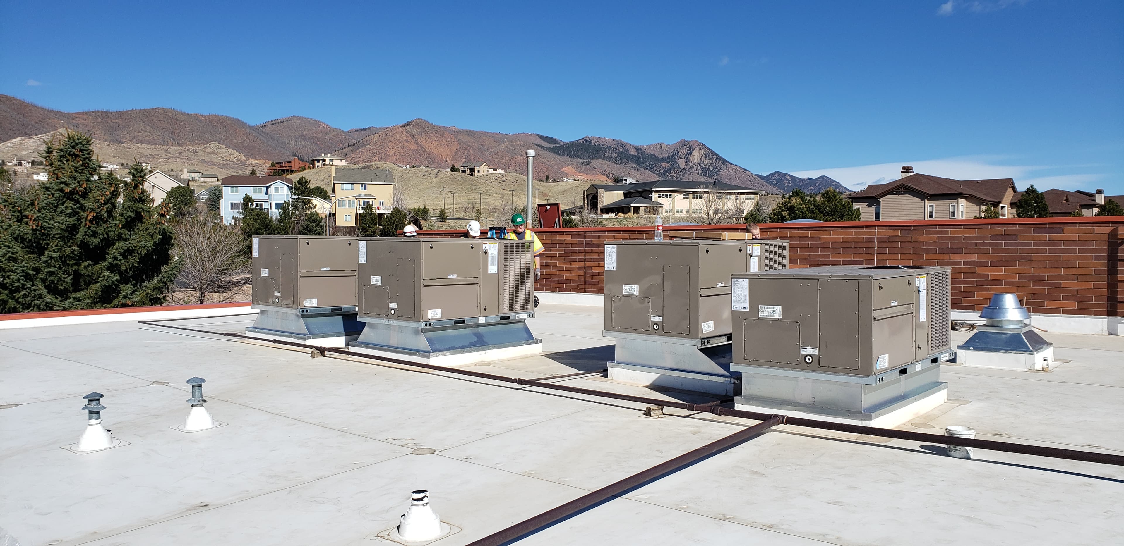 Rooftop HVAC units with Colorado mountains